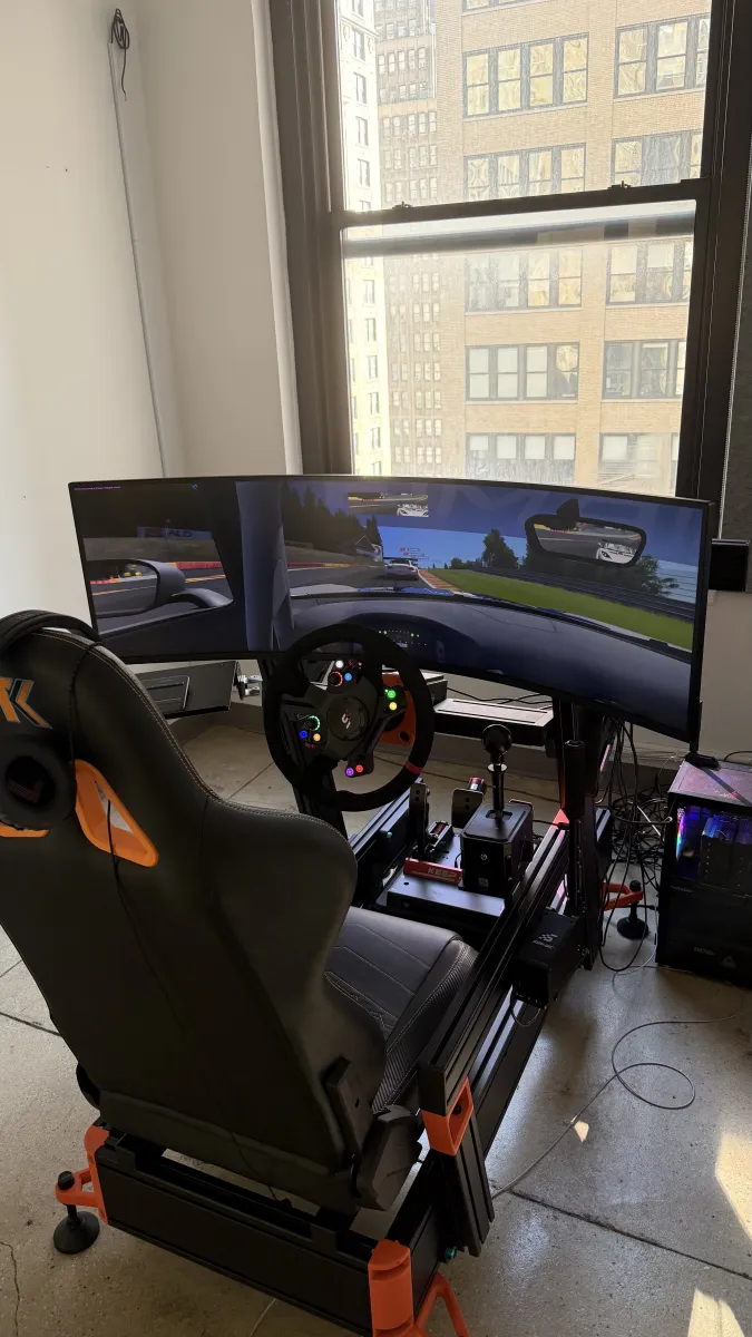 Sim rig with ultrawide and city skyline behind