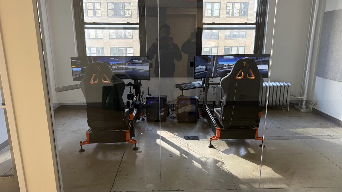 Two sim rigs in NYC office through glass wall