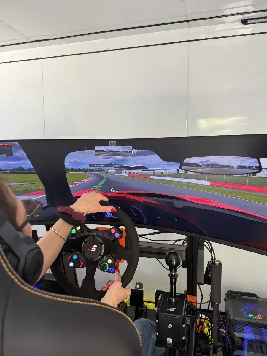 Hands on GT Neo wheel with race track on screen