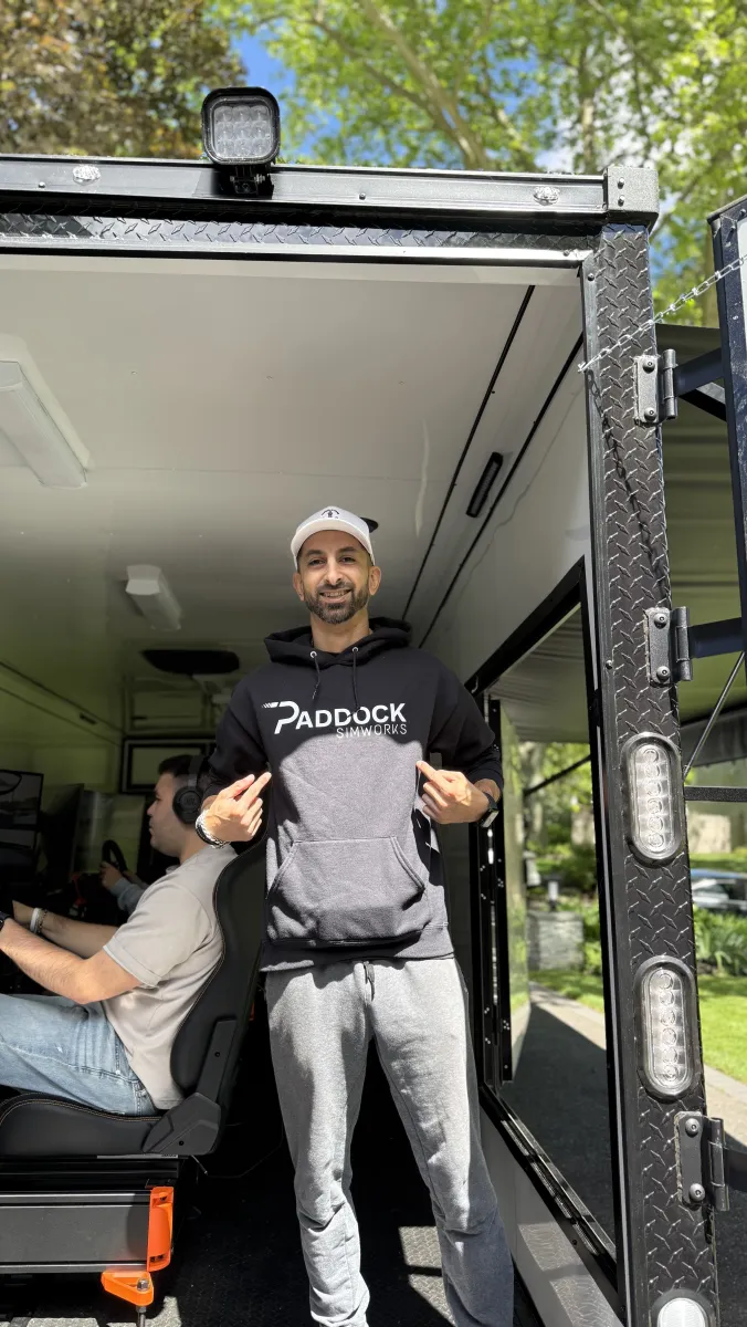 Staff in Paddock SimWorks hoodie at trailer