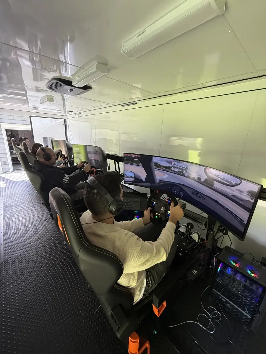 Driver racing on ultrawide screen in trailer