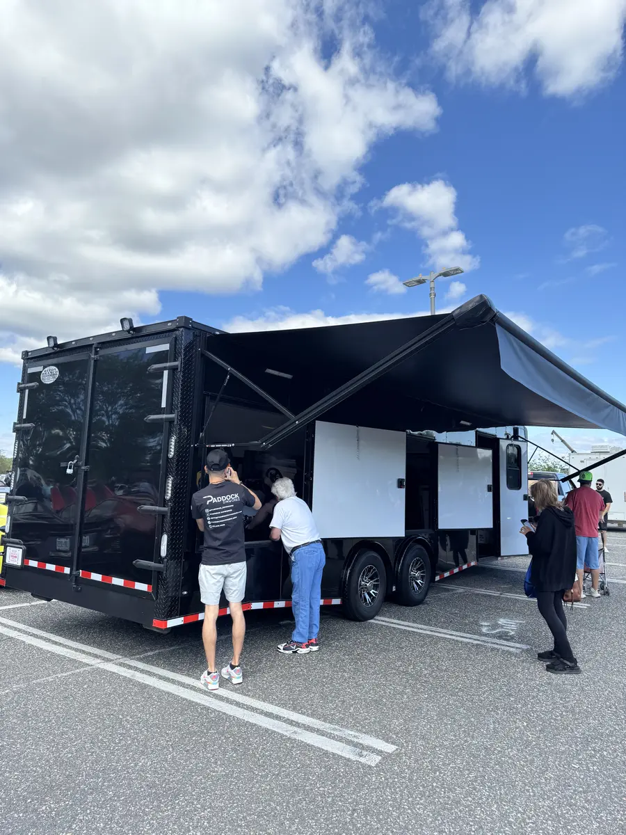 Race trailer with awning at outdoor event