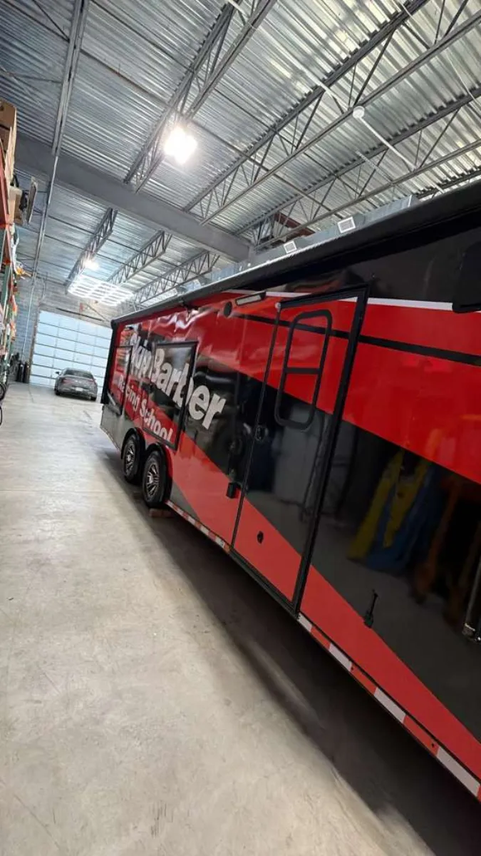 Full side view of wrapped race trailer