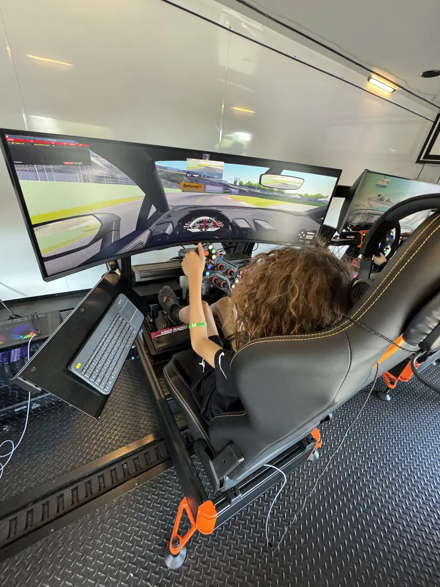 Driver racing on triple-screen setup